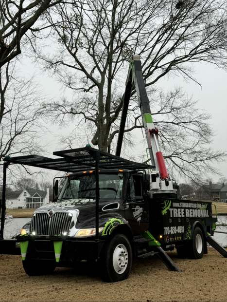 Stingray's black and green bucket truck with the boom raised