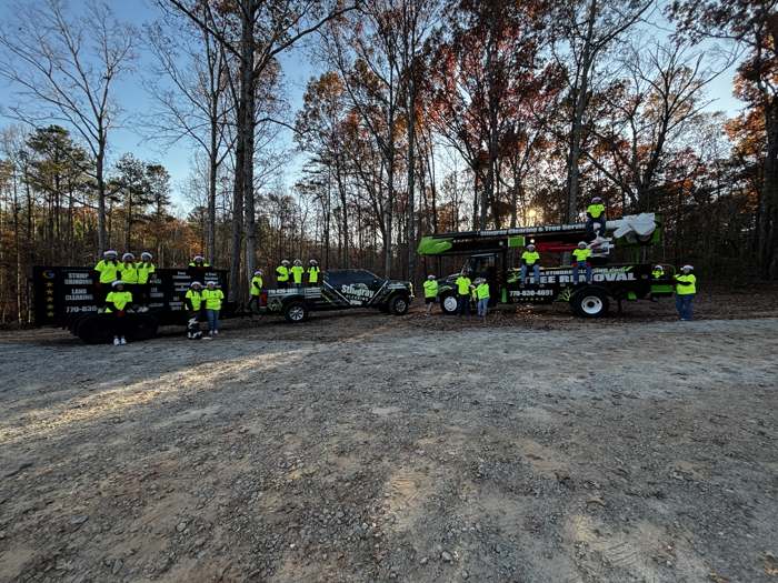 The Stingray crew in safety green lined up with the trucks, lift and trailers